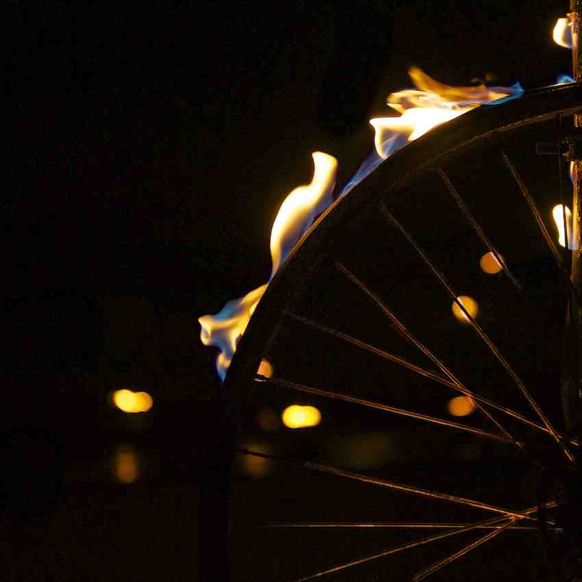 Close up of a bike wheel with the tire aflame
